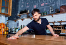 Bartender wiping down bar counter