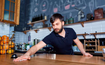 Bartender wiping down bar counter